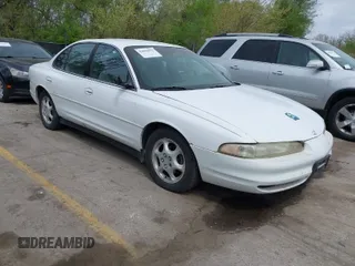 1999 Oldsmobile Intrigue GX z VIN 1G3WH52K0XF325527, wystawiony jako IAAI lot #42026992 z przebiegiem 188 092 mil mil oraz . Historia ofert i sprzedaży dostępna na DreamBid. Obrazek 1.