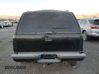 1999 Chevrolet Tahoe with VIN 3GNEC18R1XG143882, listed as a Copart auction lot 42177005 with 130,368 mi miles and Salvage title. Bid and sale history available at DreamBid. Image 6.