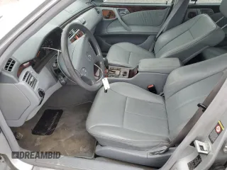 2000 Mercedes-Benz E 320 with VIN WDBJF65J1YB099417, listed as a Copart auction lot 54656915 with 130,387 mi miles and Salvage Title. Bid and sale history available at DreamBid. Image 7.
