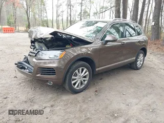 2014 Volkswagen Touareg Sport with VIN WVGEF9BP2ED007904, listed as a IAAI auction lot 41960811 with 126,230 mi miles and . Bid and sale history available at DreamBid. Image 2.
