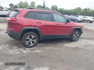 2015 Jeep Cherokee Trailhawk with VIN 1C4PJMBSXFW667469, listed as a IAAI auction lot 42438006 with 127,136 mi miles and . Bid and sale history available at DreamBid. Image 4.