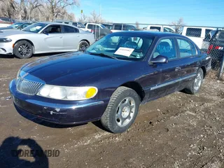 1999 Lincoln Continental with VIN 1LNHM97V8XY700644, listed as a IAAI auction lot 41641082 with 142,527 mi miles. Bid and sale history available at carsss.com. Image 2.