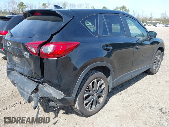 2016 Mazda CX-5 Grand Touring with VIN JM3KE4DY8G0639570, listed as a IAAI auction lot 42098512 with 126,541 mi miles and . Bid and sale history available at carsss.com. Image 4.