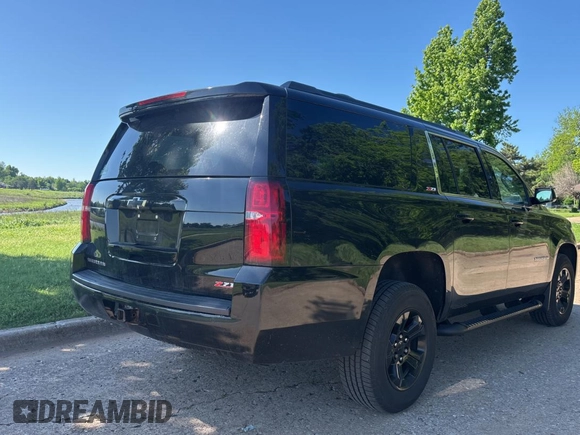 2017 Chevrolet Suburban LT with VIN 1GNSKHKC7HR377710, listed as a Copart auction lot 55876385 with 149,195 mi miles and Clean Title. Bid and sale history available at DreamBid. Image 4.