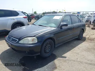 1999 Honda Civic LX with VIN JHMEJ6674XS003829, listed as a IAAI auction lot 42121298 with 238,936 mi miles. Bid and sale history available at carsss.com. Image 2.