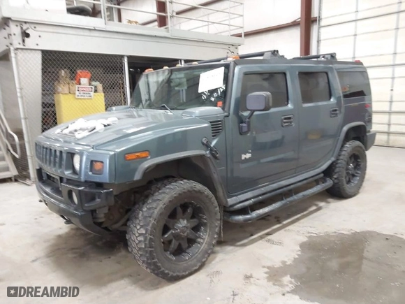 2005 Hummer H2 SUV with VIN 5GRGN23U65H132505, listed as a IAAI auction lot 41515346 with 140,944 mi miles. Bid and sale history available at carsss.com. Image 2.