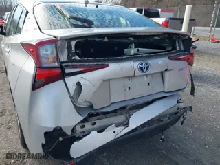 2021 Toyota Prius L Eco with VIN JTDKAMFU7M3143961, listed as a IAAI auction lot 41486032 with 58,979 mi miles. Bid and sale history available at carsss.com. Image 6.