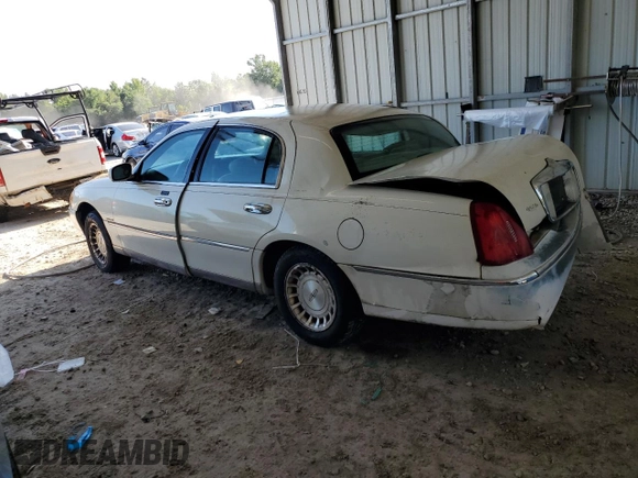 1999 Lincoln Town Car Executive with VIN 1LNHM81W2XY658371, listed as a Copart auction lot 60249045 with 191,266 mi miles and Salvage title. Bid and sale history available at DreamBid. Image 2.