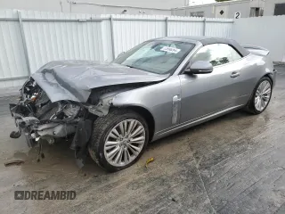 2010 Jaguar XK with VIN SAJWA4GB4ALB37114, listed as a Copart auction lot 77673824 with 99,999 mi miles and Salvage Title. Bid and sale history available at carsss.com. Image 1.