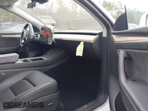 2023 Tesla Model Y Long Range with VIN 7SAYGDEE2PF765395, listed as a IAAI auction lot 41688080 with 27,792 mi miles and . Bid and sale history available at DreamBid. Image 5.