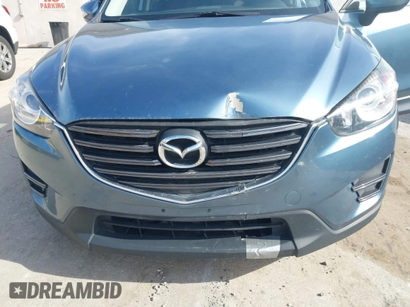 2016 Mazda CX-5 Sport with VIN JM3KE4BY0G0746034, listed as a IAAI auction lot 41842894 with 92,801 mi miles. Bid and sale history available at carsss.com. Image 6.
