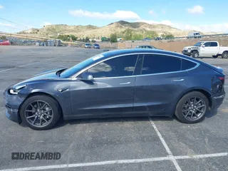 2019 Tesla Model 3 Mid Range with VIN 5YJ3E1EA6KF307456, listed as a IAAI auction lot 41944454 with 99,059 mi miles and . Bid and sale history available at DreamBid. Image 13.