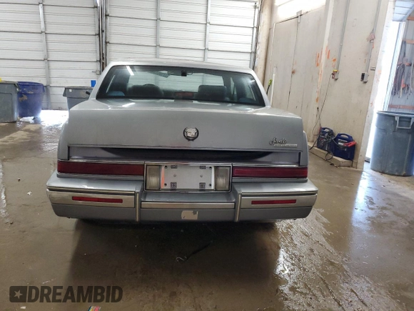 1991 Cadillac Seville z VIN 1G6KS53B2MU809384, wystawiony jako Copart lot #77185134 z przebiegiem 134 769 mil mil oraz Szkody całkowita. Historia ofert i sprzedaży dostępna na DreamBid. Obrazek 6.