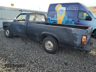 1988 Dodge Dakota z VIN 1B7GN14X5JS776983, wystawiony jako Copart lot #76597944 z przebiegiem 133 654 mil mil oraz Czysty tytuł • Clean title. Historia ofert i sprzedaży dostępna na DreamBid. Obrazek 2.