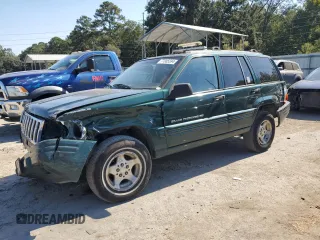 1998 Jeep Grand Cherokee with VIN 1J4FX48S8WC281615, listed as a Copart auction lot 77305594 with 128,393 mi miles and Salvage title. Bid and sale history available at DreamBid. Image 1.