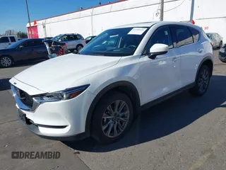 2021 Mazda CX-5 Grand Touring with VIN JM3KFBDM6M0483135, listed as a IAAI auction lot 41590430 with 33,466 mi miles. Bid and sale history available at carsss.com. Image 2.