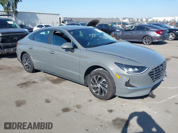 2022 Hyundai Sonata Hybrid Blue with VIN KMHL24JJ1NA041773, listed as a IAAI auction lot 41043553 with 23,696 mi miles. Bid and sale history available at carsss.com. Image 1.