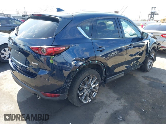 2020 Mazda CX-5 Grand Touring with VIN JM3KFADM6L1830093, listed as a IAAI auction lot 41699672 with 66,769 mi miles. Bid and sale history available at carsss.com. Image 4.