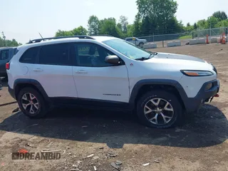 2014 Jeep Cherokee Trailhawk z VIN 1C4PJMBS0EW188976, wystawiony jako IAAI lot #42587233 z przebiegiem 191 670 mil mil oraz . Historia ofert i sprzedaży dostępna na DreamBid. Obrazek 13.