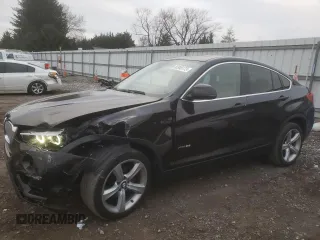 2015 BMW X4 xDrive28i with VIN 5UXXW3C55F0M88228, listed as a Copart auction lot 82940173 with 73,519 mi miles. Bid and sale history available at carsss.com. Image 1.