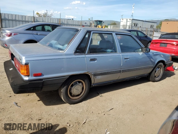 1986 Toyota Camry z VIN JT2SV12E3G6021210, wystawiony jako Copart lot #49623985 z przebiegiem 144 064 mil mil oraz Czysty tytuł • Clean title. Historia ofert i sprzedaży dostępna na DreamBid. Obrazek 3.