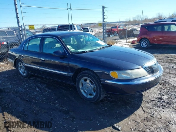 1999 Lincoln Continental with VIN 1LNHM97V8XY700644, listed as a IAAI auction lot 41641082 with 142,527 mi miles. Bid and sale history available at carsss.com. Image 1.