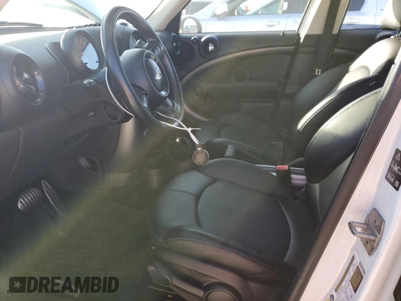 2016 MINI Countryman S with VIN WMWZC5C51GWU01290, listed as a Copart auction lot 77684384 with 106,811 mi miles and Salvage Title. Bid and sale history available at DreamBid. Image 7.
