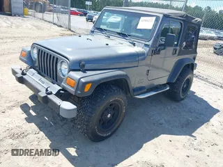 2002 Jeep Wrangler Sport z VIN 1J4FA49S62P731507, wystawiony jako IAAI lot #42584222 z przebiegiem 206 661 mil mil oraz . Historia ofert i sprzedaży dostępna na DreamBid. Obrazek 2.