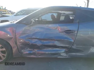 2016 Hyundai Veloster with VIN KMHTC6AD3GU283985, listed as a IAAI auction lot 41872103 with 153,949 mi miles. Bid and sale history available at carsss.com. Image 6.