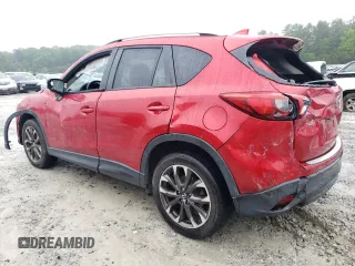 2016 Mazda CX-5 Grand Touring z VIN JM3KE2DY8G0623423, wystawiony jako Copart lot #58599545 z przebiegiem 131 932 mil mil oraz Szkoda całkowita • Salvage title. Historia ofert i sprzedaży dostępna na DreamBid. Obrazek 2.