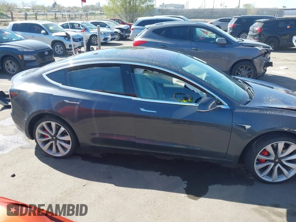 2018 Tesla Model 3 Long Range Battery with VIN 5YJ3E1EBXJF055203, listed as a IAAI auction lot 42019770 with 57,379 mi miles and . Bid and sale history available at DreamBid. Image 13.