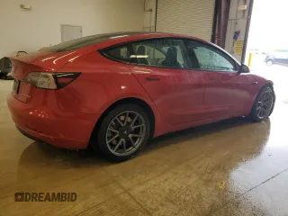 2022 Tesla Model 3 Long Range with VIN 5YJ3E1EBXNF285779, listed as a Copart auction lot 54630135 with 129,097 mi miles and Clean Title. Bid and sale history available at DreamBid. Image 3.