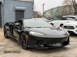 2023 McLaren GT with VIN SBM22GCA3PW002548, listed as a Copart auction lot 52157855 with 779 mi miles and Salvage Title. Bid and sale history available at carsss.com. Image 1.