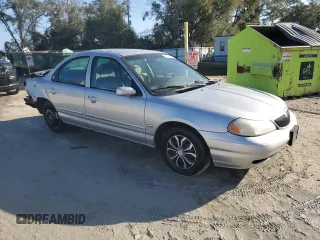 1998 Mercury Mystique z VIN 1MELM6534WK600653, wystawiony jako Copart lot #45148215 z przebiegiem 122 878 mil mil oraz Szkody całkowita. Historia ofert i sprzedaży dostępna na DreamBid. Obrazek 4.