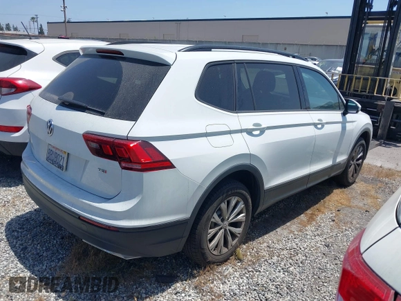 2018 Volkswagen Tiguan S with VIN 3VV1B7AX8JM032990, listed as a IAAI auction lot 42279807 with 74,185 mi miles and . Bid and sale history available at DreamBid. Image 4.