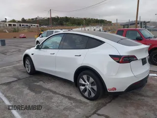 2023 Tesla Model Y Long Range with VIN 7SAYGDEE2PF874729, listed as a IAAI auction lot 41518376 with 10,927 mi miles and . Bid and sale history available at DreamBid. Image 3.