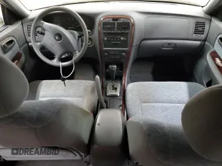 2005 Kia Optima LX z VIN KNAGD128155423463, wystawiony jako Copart lot #87441284 z przebiegiem 143 193 mil mil oraz Szkoda całkowita • Salvage title. Historia ofert i sprzedaży dostępna na DreamBid. Obrazek 8.