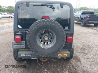 2004 Jeep Wrangler Sport z VIN 1J4FA49S94P792689, wystawiony jako IAAI lot #42394196 z przebiegiem Nie podano mil oraz . Historia ofert i sprzedaży dostępna na DreamBid. Obrazek 17.