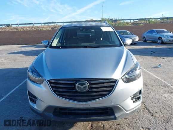 2016 Mazda CX-5 Grand Touring z VIN JM3KE2DY8G0709573, wystawiony jako IAAI lot #42021005 z przebiegiem 113 941 mil mil oraz . Historia ofert i sprzedaży dostępna na DreamBid. Obrazek 13.