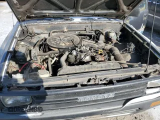 1990 Toyota Pickup z VIN JT4RN81R3L0056975, wystawiony jako Copart lot #88053235 z przebiegiem 144 149 mil mil oraz Tytuł czysty. Historia ofert i sprzedaży dostępna na DreamBid. Obrazek 11.