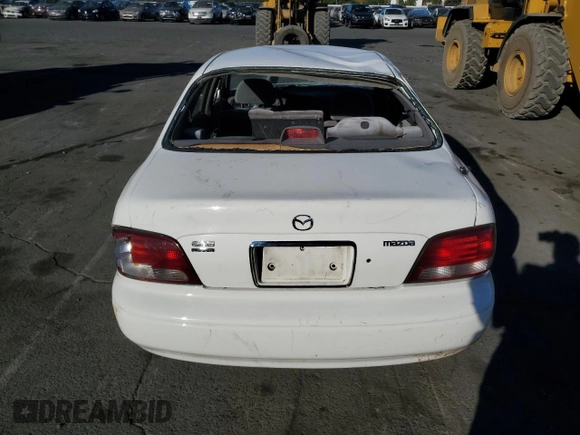 1999 Mazda 626 LX z VIN 1YVGF22D4X5882600, wystawiony jako Copart lot #69031604 z przebiegiem Nie podano mil oraz Szkoda całkowita • Salvage title. Historia ofert i sprzedaży dostępna na DreamBid. Obrazek 6.