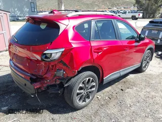2016 Mazda CX-5 Grand Touring with VIN JM3KE2DY3G0686588, listed as a IAAI auction lot 41697312 with 65,090 mi miles. Bid and sale history available at carsss.com. Image 4.