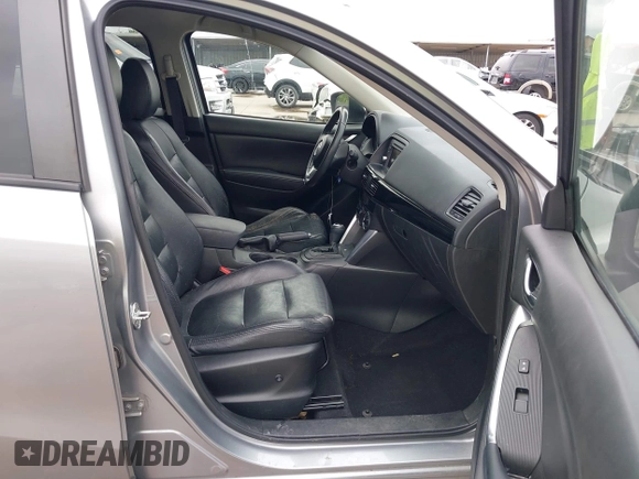 2014 Mazda CX-5 Touring z VIN JM3KE2CY8E0369145, wystawiony jako IAAI lot #42462985 z przebiegiem 155 480 mil mil oraz . Historia ofert i sprzedaży dostępna na DreamBid. Obrazek 5.
