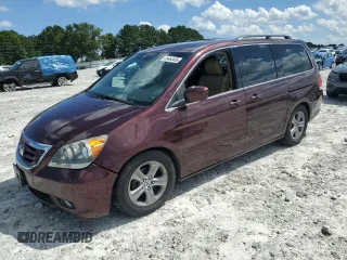 2010 Honda Odyssey Touring with VIN 5FNRL3H90AB023140, listed as a Copart auction lot 59464485 with 184,327 mi miles and Salvage title. Bid and sale history available at DreamBid. Image 1.