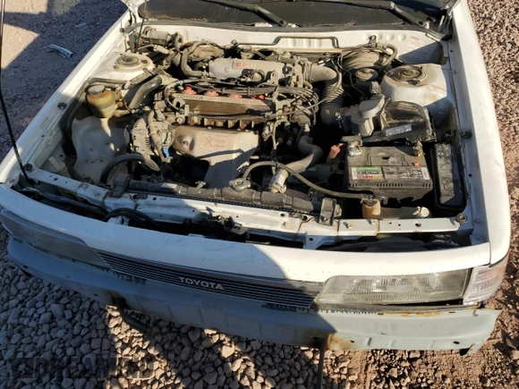 1989 Toyota Camry z VIN 4T1SV24E5KU019985, wystawiony jako Copart lot #81200104 z przebiegiem 207 103 mil mil oraz Szkoda całkowita • Salvage title. Historia ofert i sprzedaży dostępna na DreamBid. Obrazek 11.