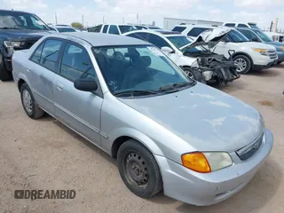 1999 Mazda Protege DX z VIN JM1BJ2228X0151145, wystawiony jako IAAI lot #42181329 z przebiegiem 287 846 mil mil oraz . Historia ofert i sprzedaży dostępna na DreamBid. Obrazek 1.