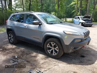2015 Jeep Cherokee Trailhawk with VIN 1C4PJMBS2FW704983, listed as a IAAI auction lot 42514378 with 44,248 mi miles and . Bid and sale history available at DreamBid. Image 1.