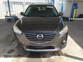2016 Mazda CX-5 Touring z VIN JM3KE2CY4G0805072, wystawiony jako Copart lot #58435535 z przebiegiem 146 323 mil mil oraz Szkoda całkowita • Salvage title. Historia ofert i sprzedaży dostępna na DreamBid. Obrazek 5.