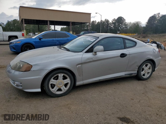 2003 Hyundai Tiburon GT z VIN KMHHN65F13U013420, wystawiony jako Copart lot #51234495 z przebiegiem 230 612 mil mil oraz Szkoda całkowita • Salvage title. Historia ofert i sprzedaży dostępna na DreamBid. Obrazek 1.