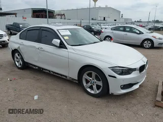 2012 BMW 3 Series 328i with VIN WBA3A5C51CF349987, listed as a IAAI auction lot 42013599 with 256,461 mi miles. Bid and sale history available at carsss.com. Image 1.